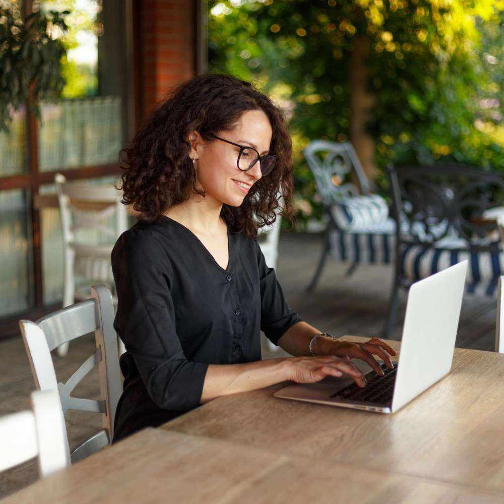 A person at a laptop at the kitchen table, calmly comparing healthcare options.